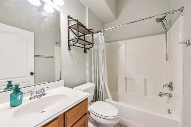 a bathroom with a sink toilet tub and shower