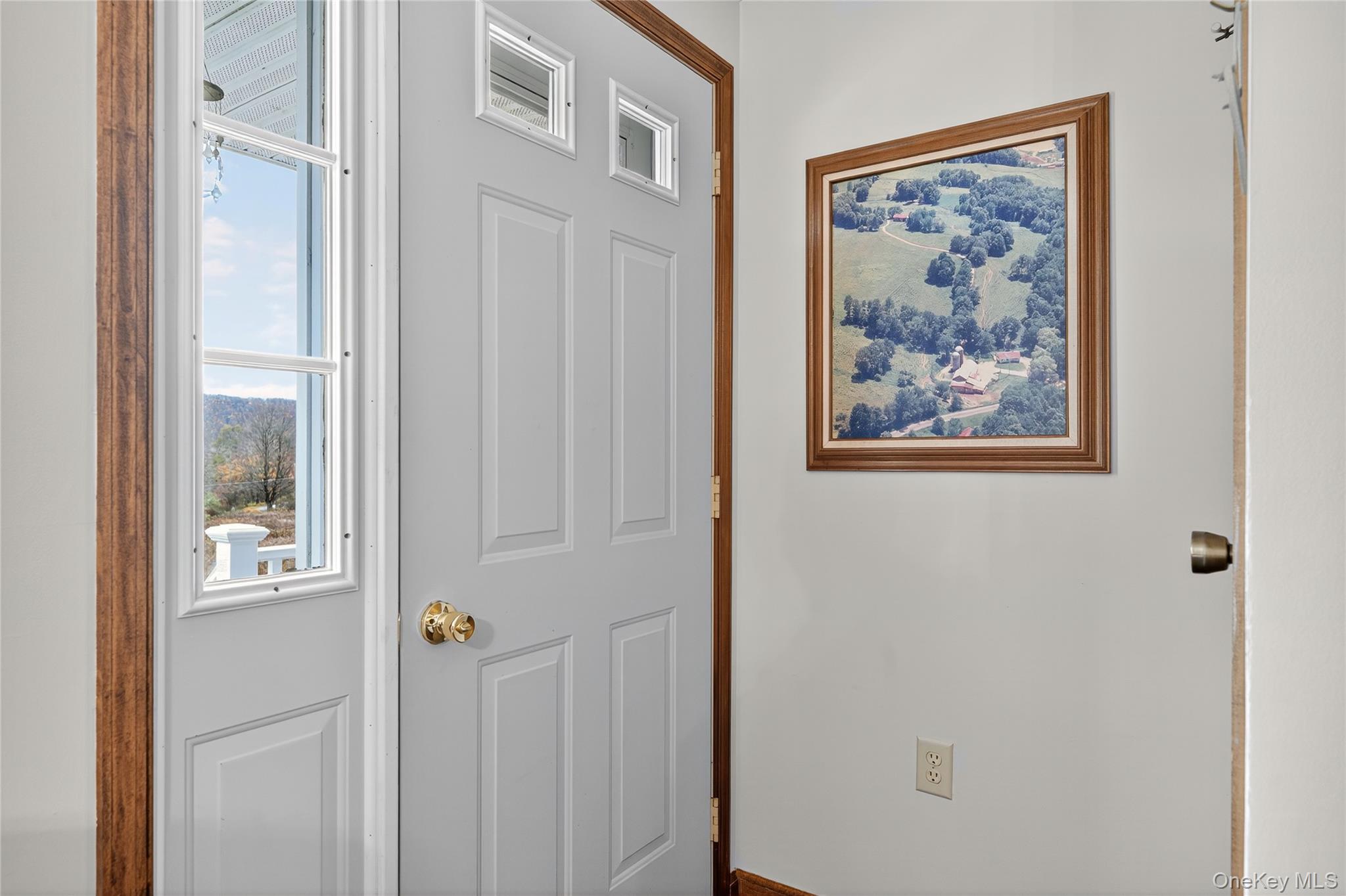 812 Obernberg Road North Branch, NY 12766 - Photo 9 of 43 a view of a hallway with a refrigerator and a painting on the wall