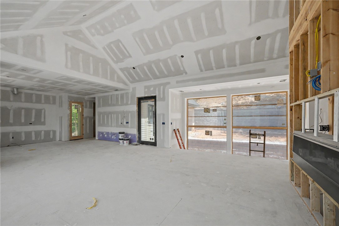 166 Ellenburg Creek Road Sunset, SC 29685 - Photo 5 of 20 Discover a spacious unfinished great room with a vaulted ceiling and ample natural light.