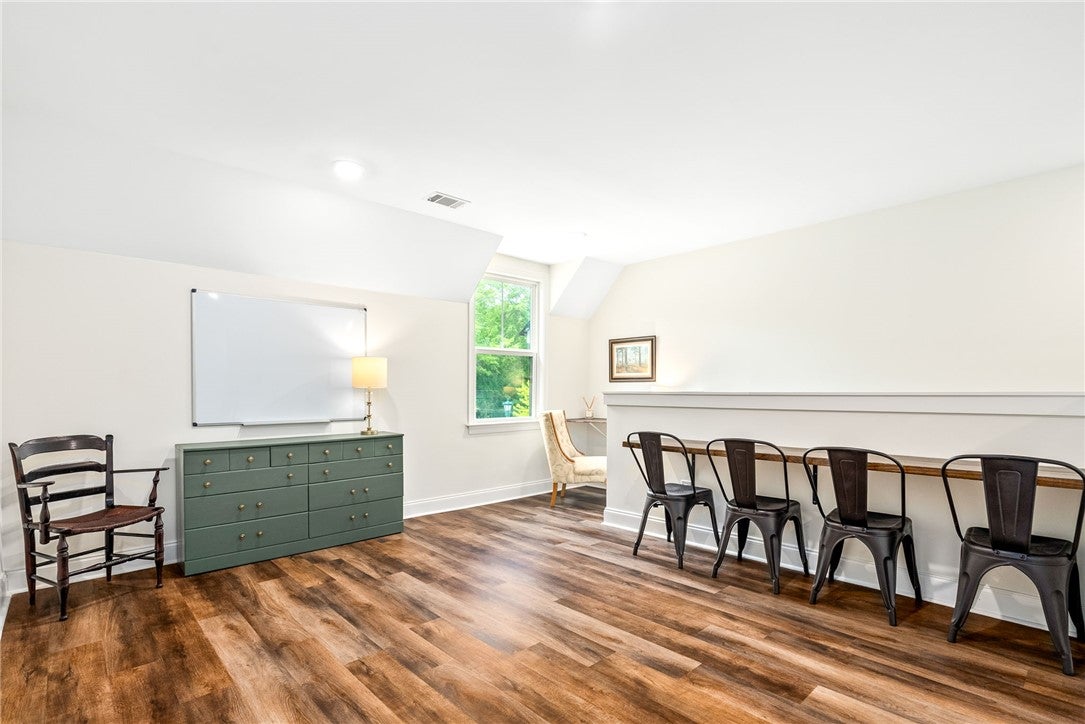 2324 Rutland Road Auburn, AL 36832 - Photo 18 of 22 This bright room features durable flooring and sloped ceilings, perfect for a versatile living space.