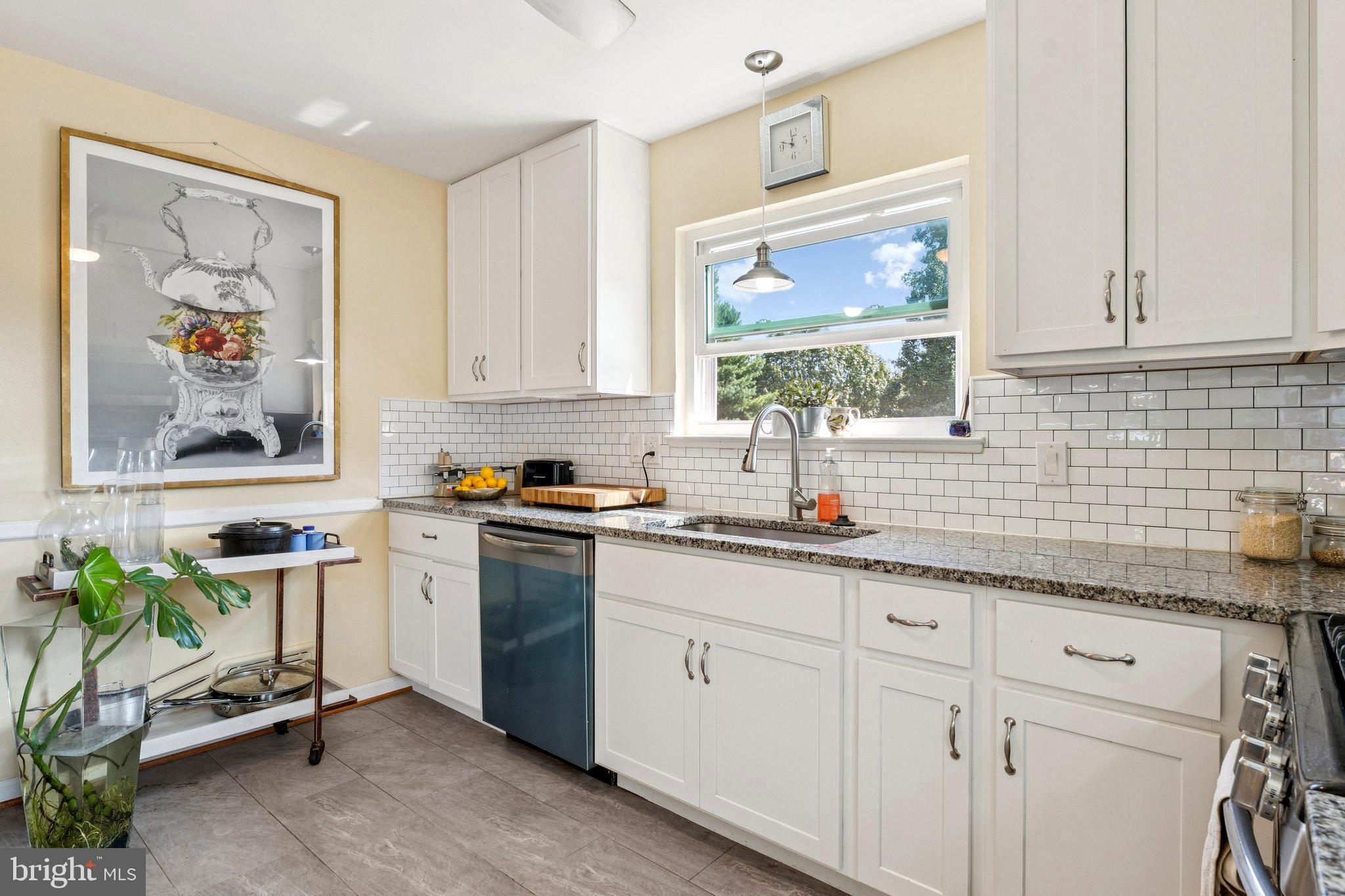 6200 Gilston Park Road Catonsville, MD 21228 - Photo 11 of 34 a kitchen with stainless steel appliances white cabinets and a window