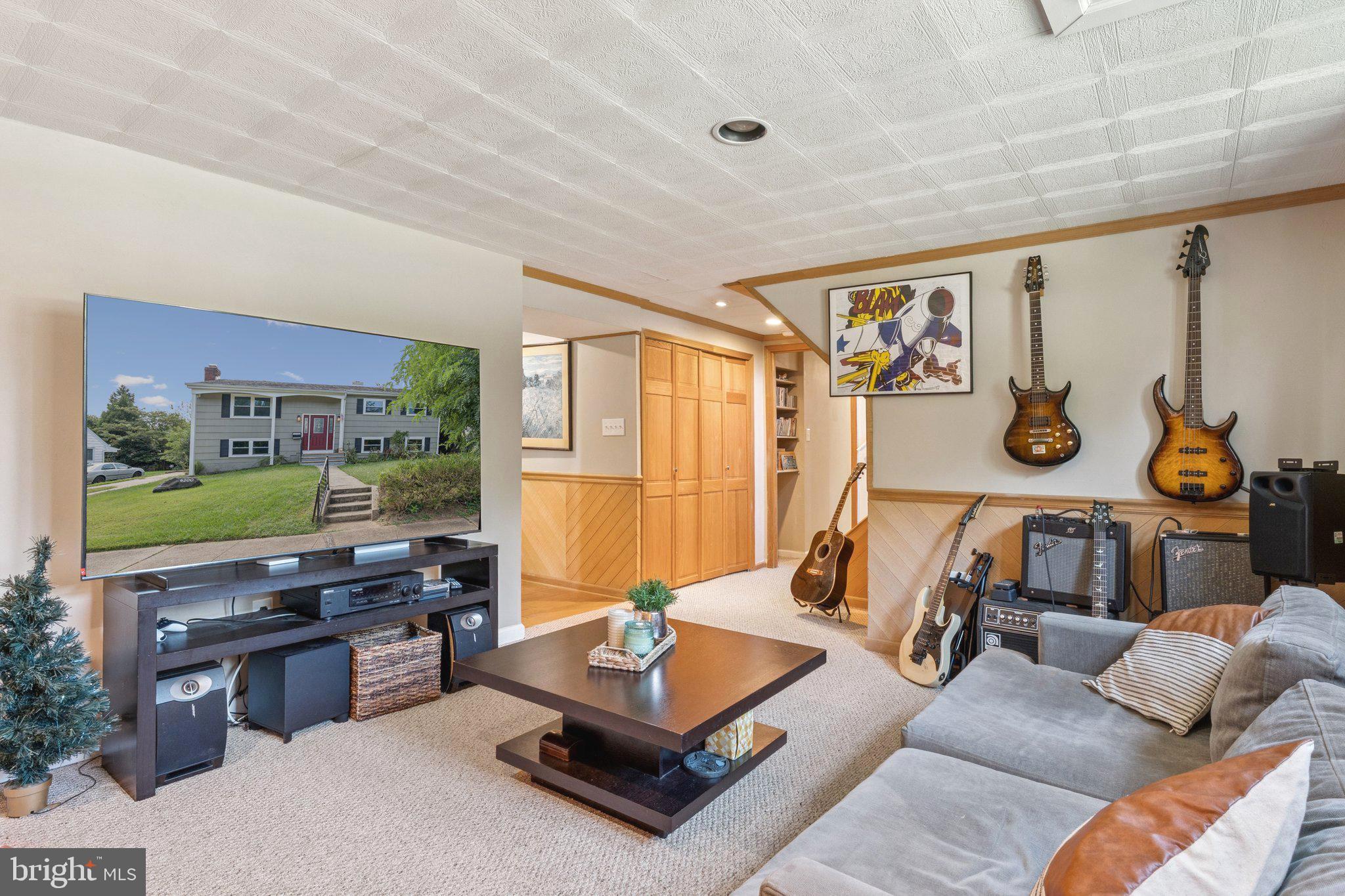 6200 Gilston Park Road Catonsville, MD 21228 - Photo 20 of 34 a living room with furniture a flat screen tv and a floor to ceiling window