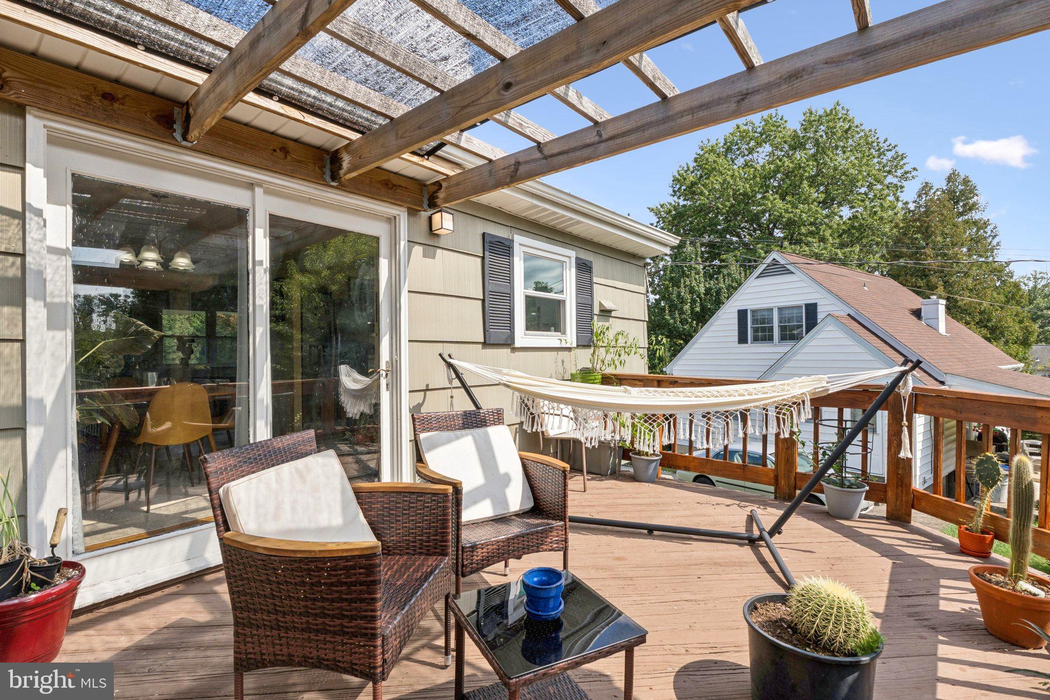 6200 Gilston Park Road Catonsville, MD 21228 - Photo 28 of 34 a balcony of a house with barbeque oven table and chairs