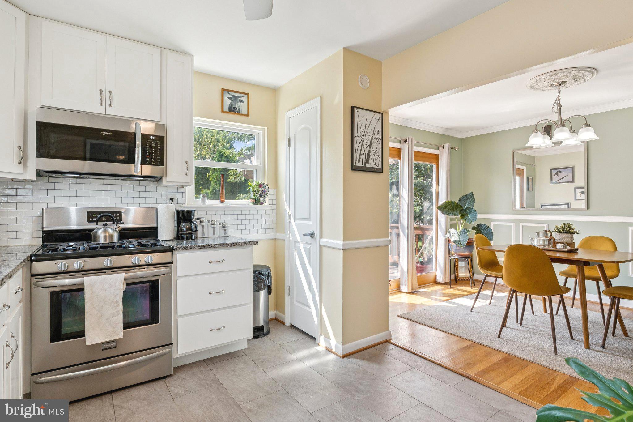 6200 Gilston Park Road Catonsville, MD 21228 - Photo 9 of 34 a kitchen with stainless steel appliances granite countertop a stove a sink and a refrigerator