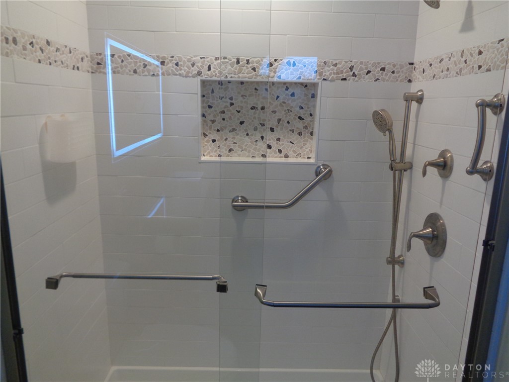 80 Villa Pointe Drive Springboro, OH 45066 - Photo 14 of 19 This sleek shower features decorative tile accents and convenient grab bars.