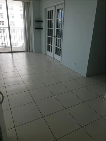 a view of a livingroom with an empty space and a window