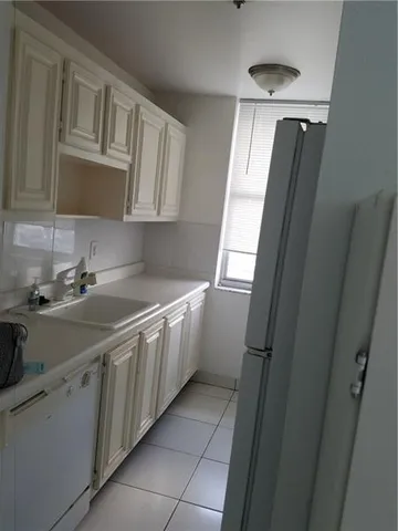 a kitchen with cabinets a sink and appliances
