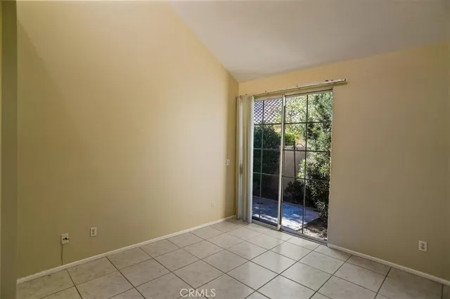 a view of an empty room with glass door