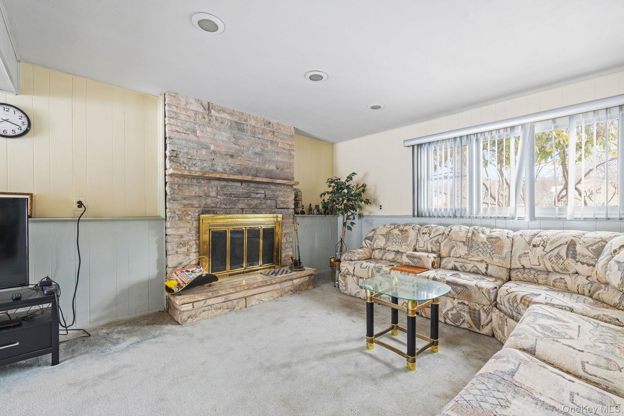 38 Haller Crescent Spring Valley, NY 10977 - Photo 17 of 24 Lower level with fireplace, sliders to yard