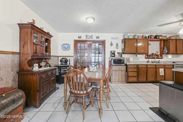a kitchen with stainless steel appliances kitchen island granite countertop a sink and cabinets