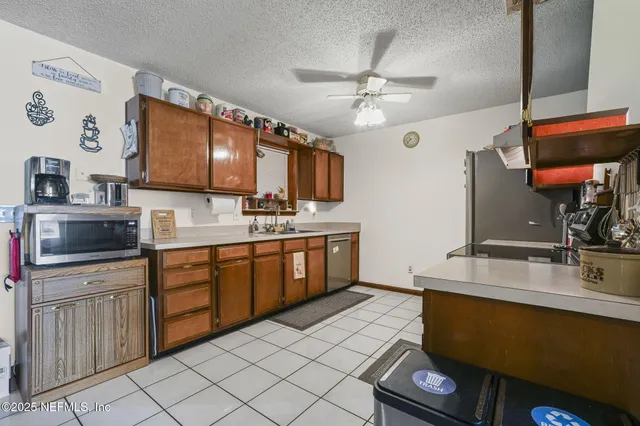 a kitchen with stainless steel appliances wooden cabinets a sink and a stove