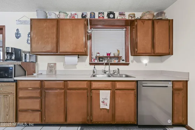 a kitchen with sink cabinets and a wooden floor