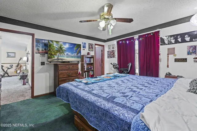 a bed room with a bed and a television