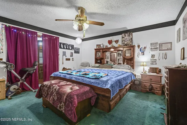 a bedroom with a bed dresser and a large mirror