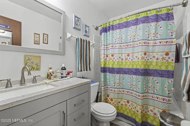a bathroom with a sink mirror vanity and toilet