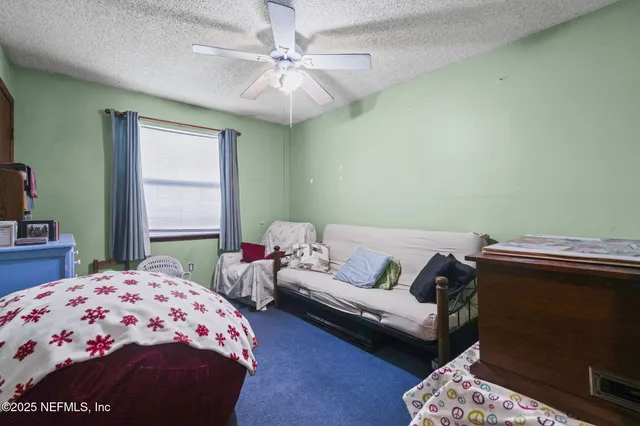 a bedroom with a bed and a couch