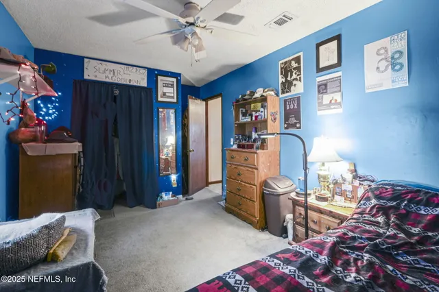 a bedroom with furniture and a chandelier