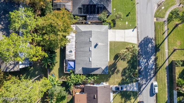 an aerial view of a house with a yard and garden