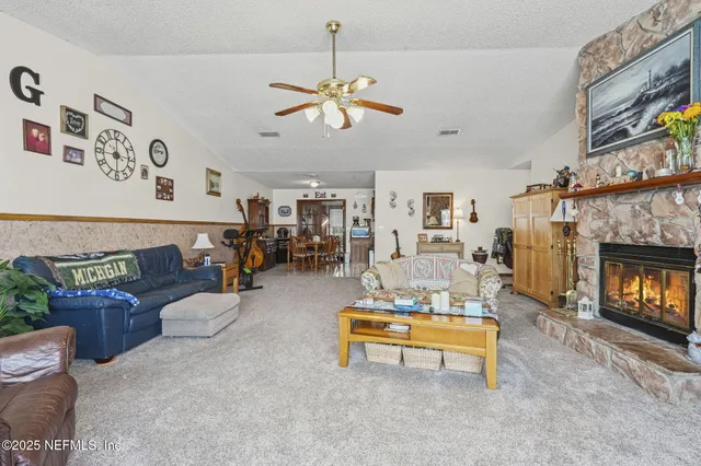 a living room with furniture and a fireplace