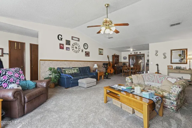a living room with furniture and flowers