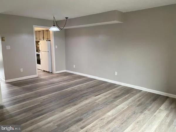 a view of a room with wooden floor and door