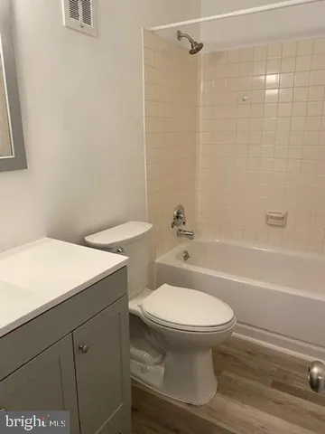 a bathroom with a toilet and a bathtub