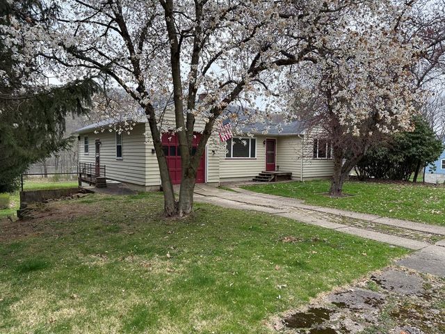 a front view of a house with a yard