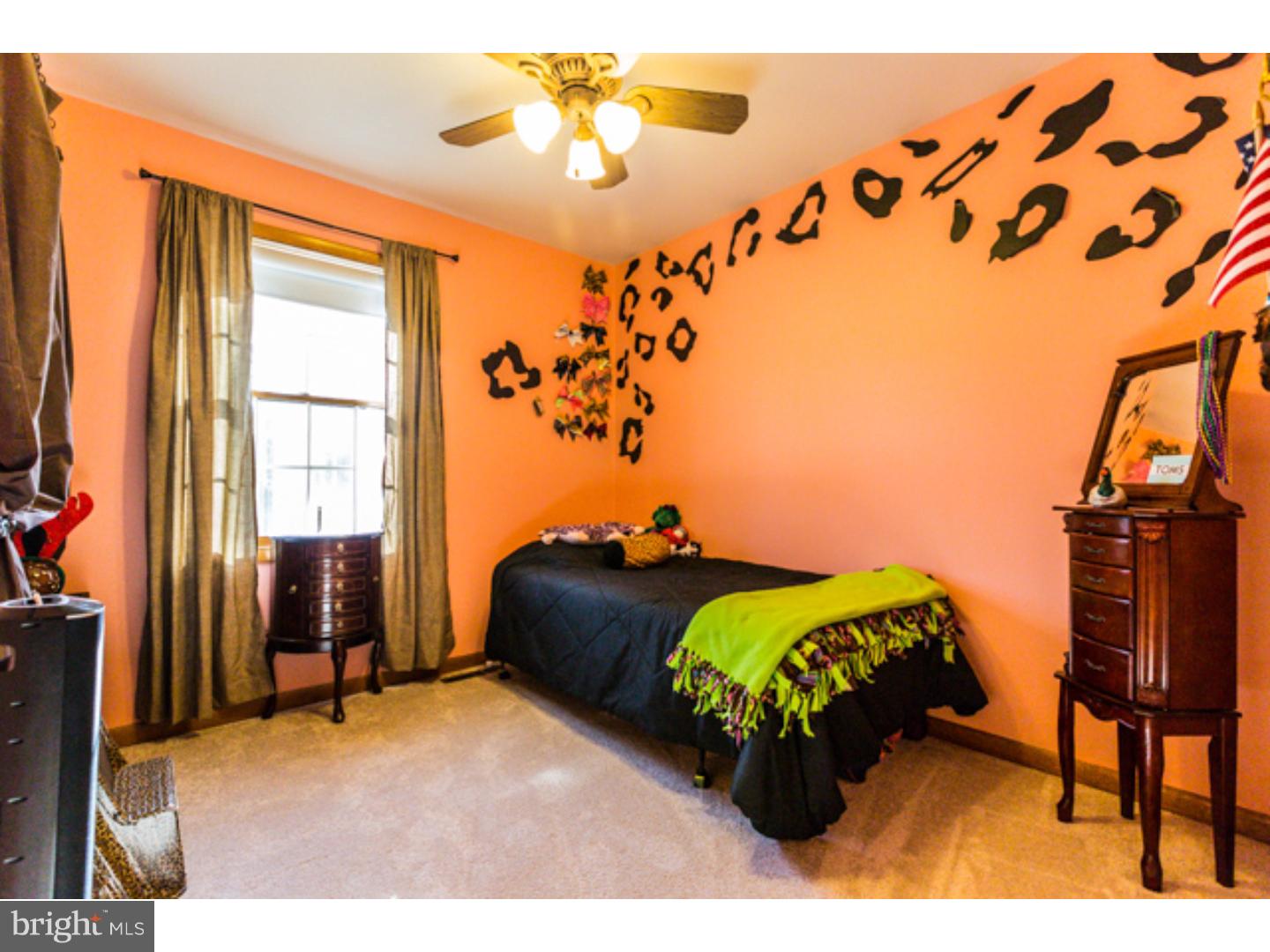 232 Cambridge Road Coatesville, PA 19320 - Photo 16 of 25 a bed sitting in a bedroom next to a window