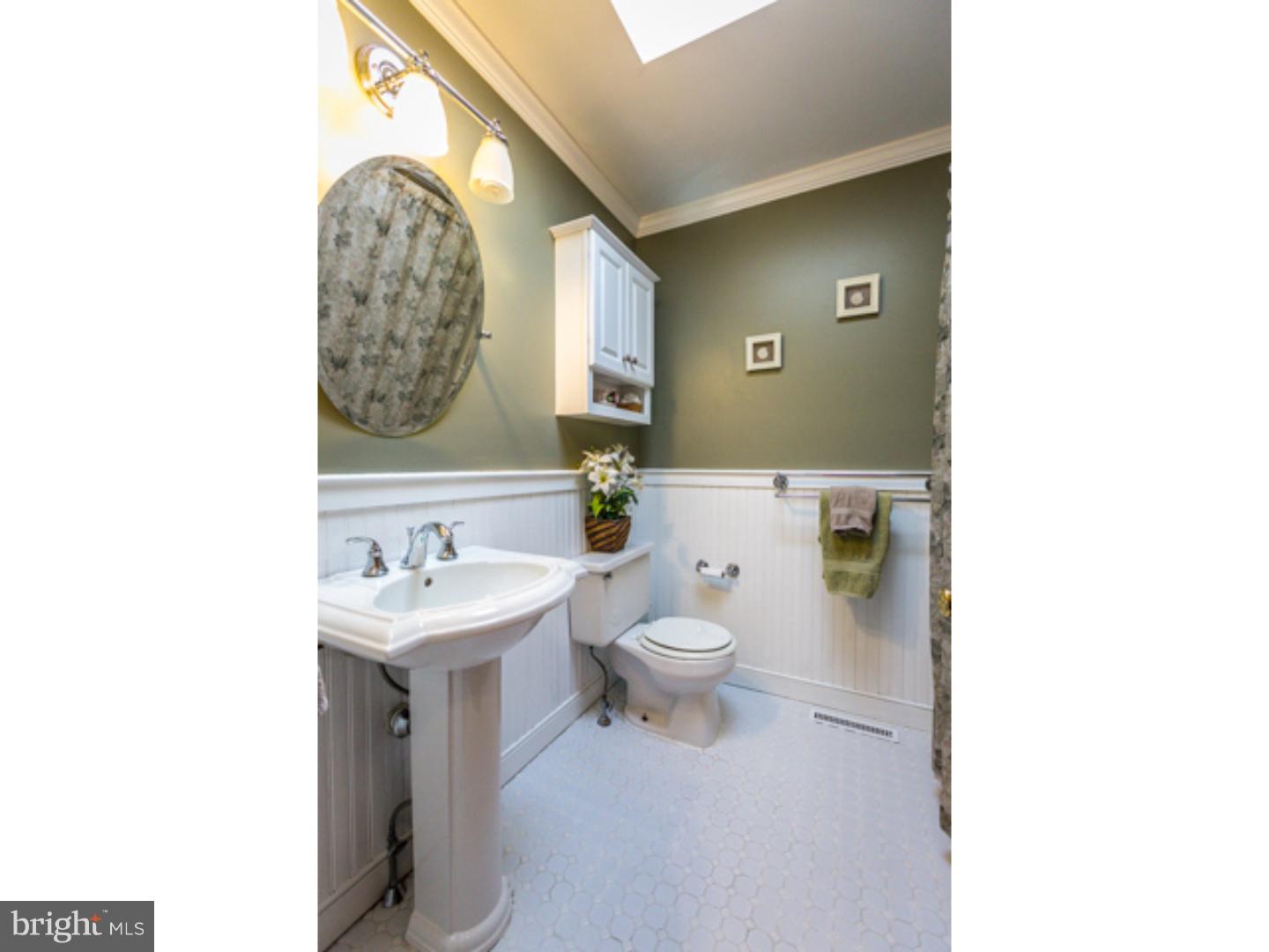 232 Cambridge Road Coatesville, PA 19320 - Photo 19 of 25 a bathroom with a toilet sink and mirror