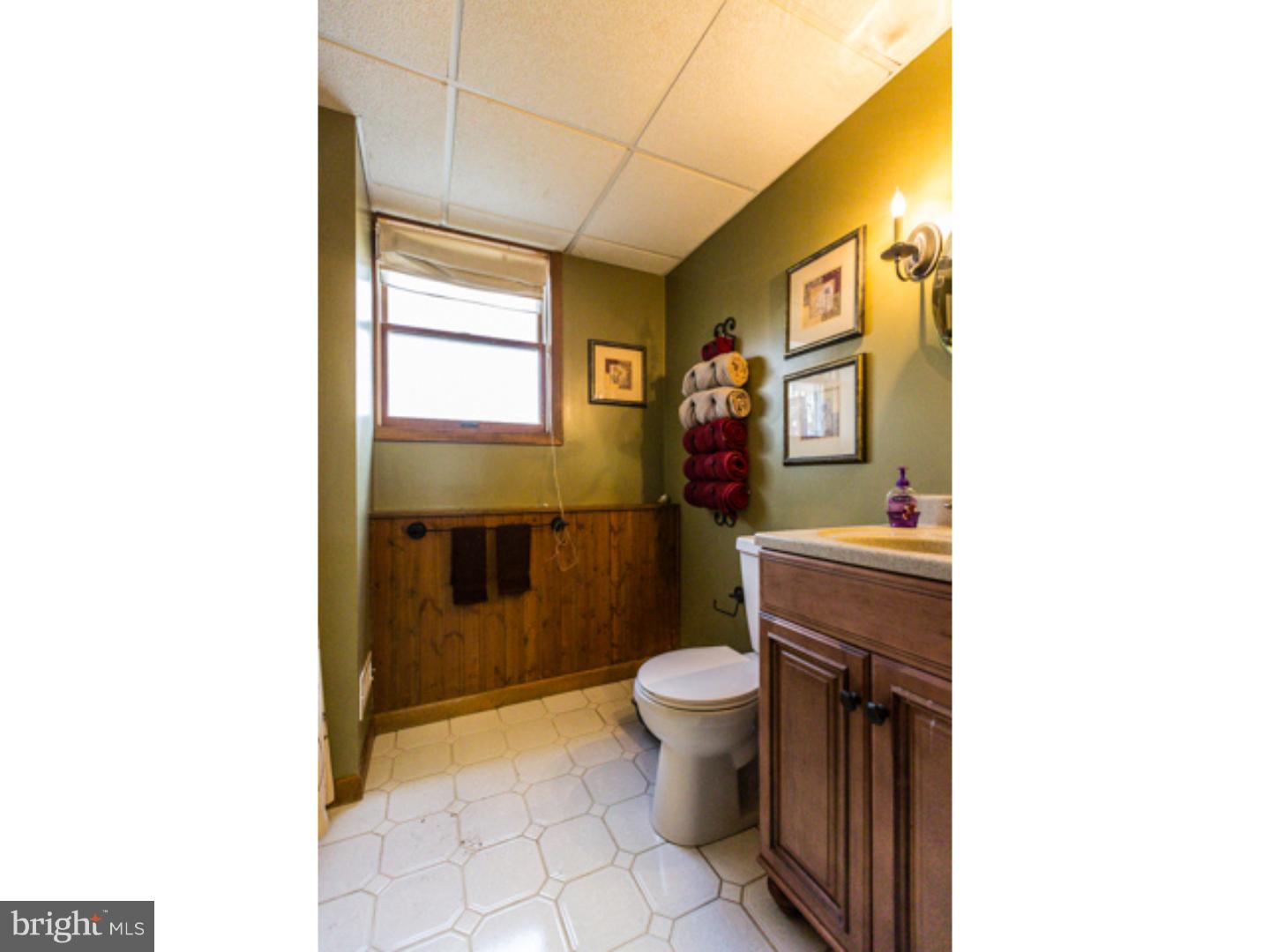 232 Cambridge Road Coatesville, PA 19320 - Photo 24 of 25 a bathroom with a toilet sink and mirror