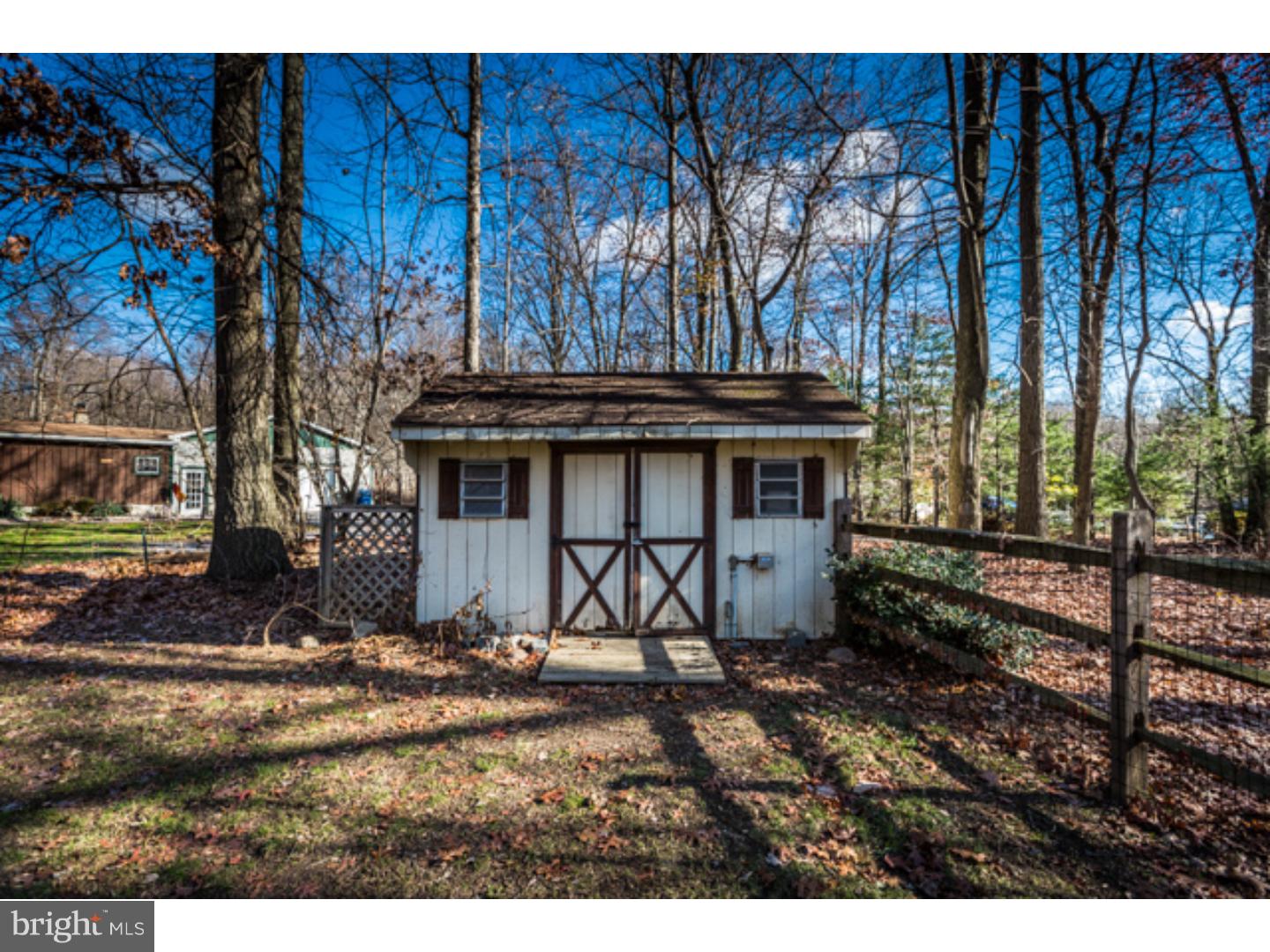 232 Cambridge Road Coatesville, PA 19320 - Photo 25 of 25 a view of a backyard with a large tree