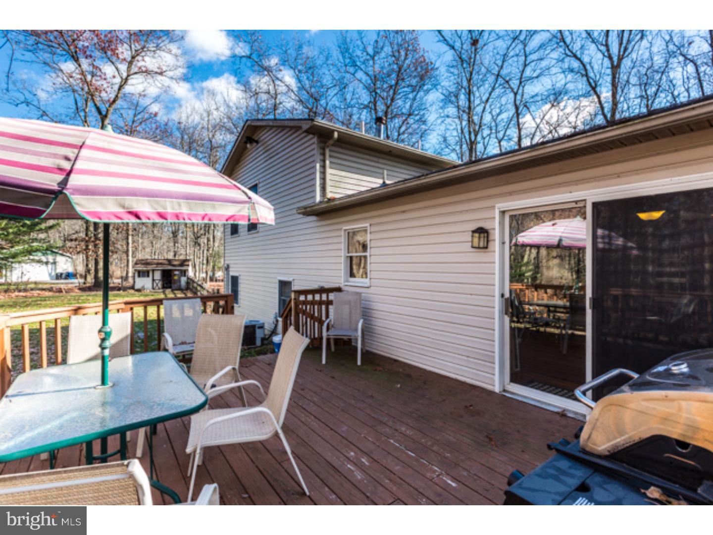 232 Cambridge Road Coatesville, PA 19320 - Photo 5 of 25 a view of a patio with a table and chairs under an umbrella
