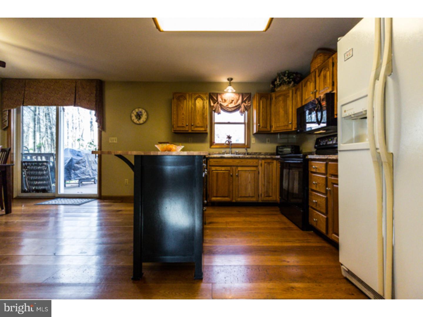 232 Cambridge Road Coatesville, PA 19320 - Photo 6 of 25 a kitchen with stainless steel appliances granite countertop a stove a sink and a refrigerator