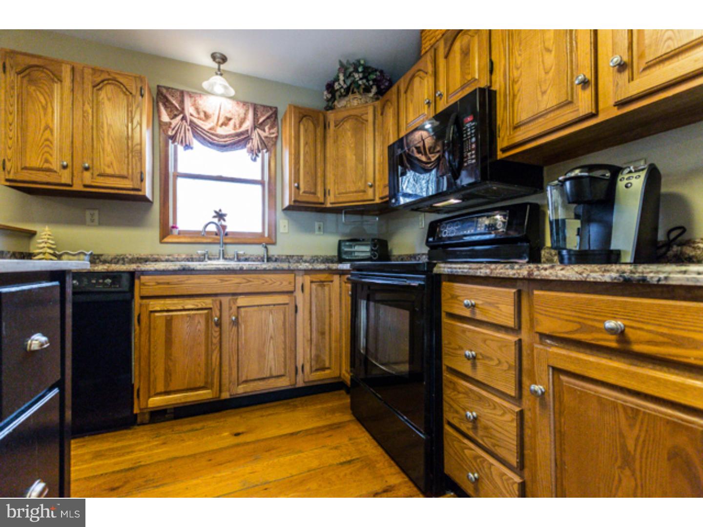 232 Cambridge Road Coatesville, PA 19320 - Photo 10 of 25 a kitchen with stainless steel appliances granite countertop a stove a sink and a microwave