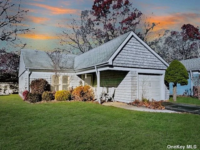a front view of a house with a yard table and chairs