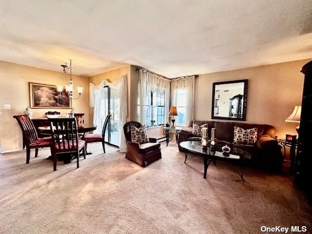 a living room with furniture and large windows