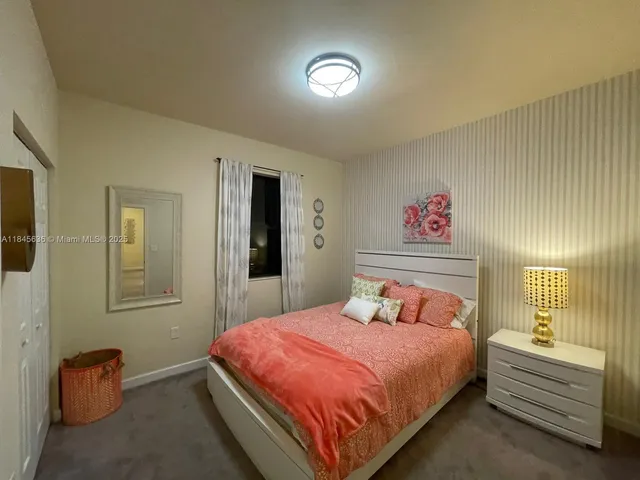 a bedroom with a bed and a lamp