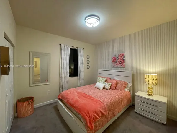 a bedroom with a bed and a lamp