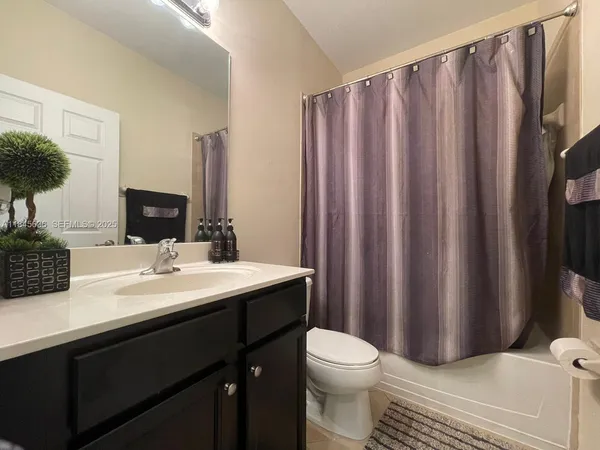 a bed sitting in a bedroom next to a lamp