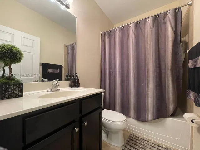 a bed sitting in a bedroom next to a lamp