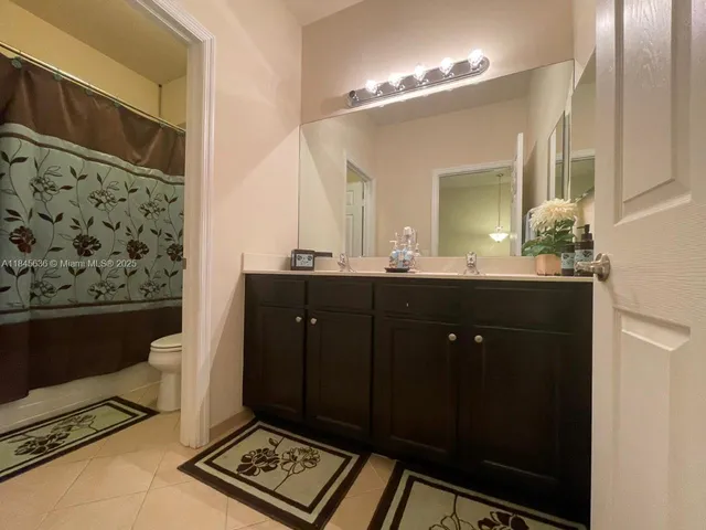 a bathroom with a double vanity sink and a mirror
