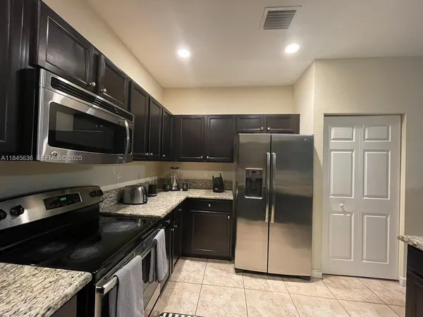 a kitchen with a refrigerator stove and microwave