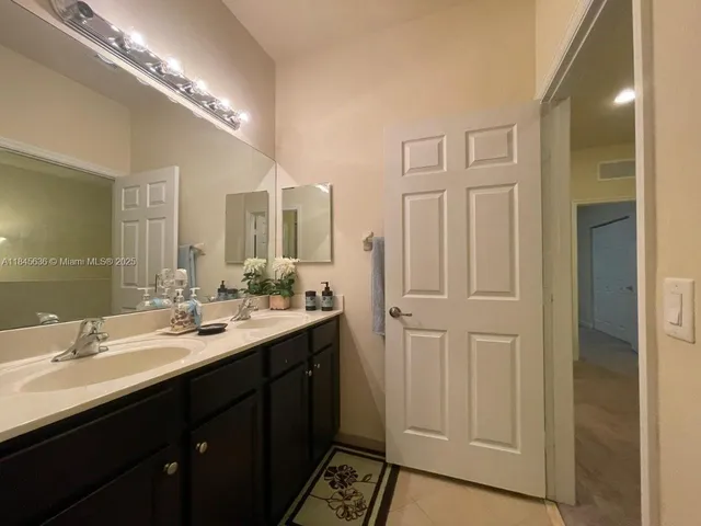 a bedroom with a bed and a lamp