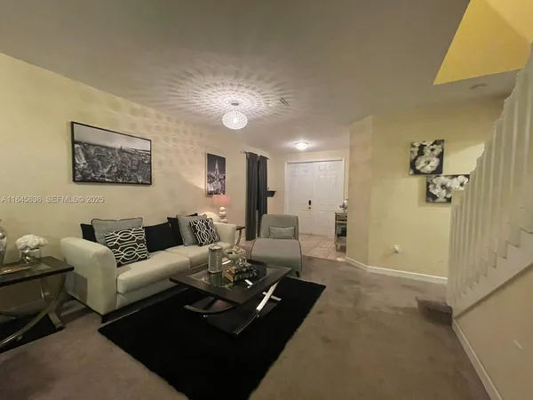 a living room with furniture rug and window