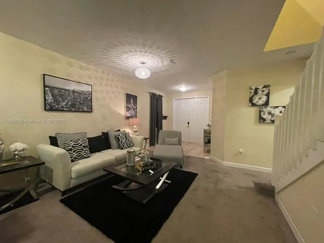 a living room with furniture rug and window