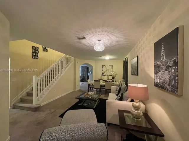 a living room with furniture and a large window