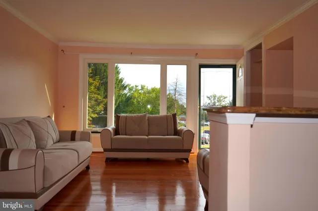a living room with furniture and a floor to ceiling window