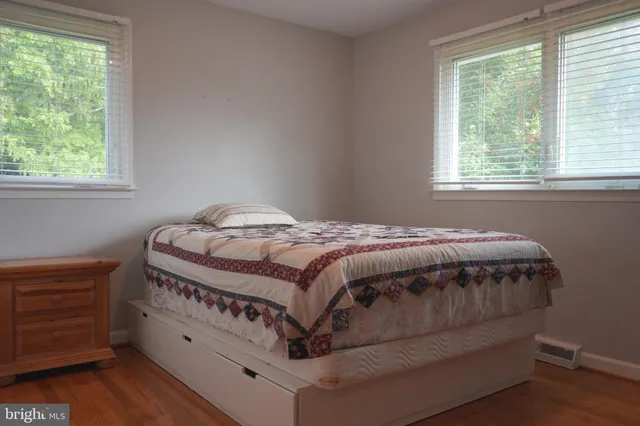 a bedroom with a bed next to a window