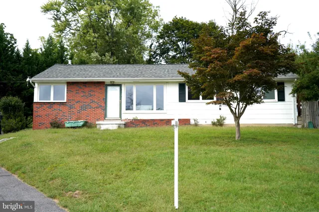 a house that has a tree in front of a house