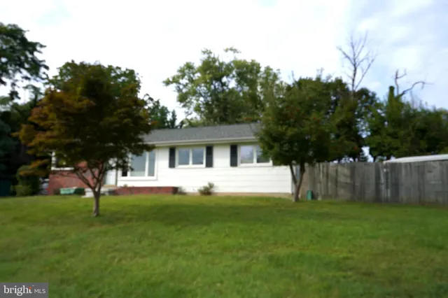 a front view of house with a garden